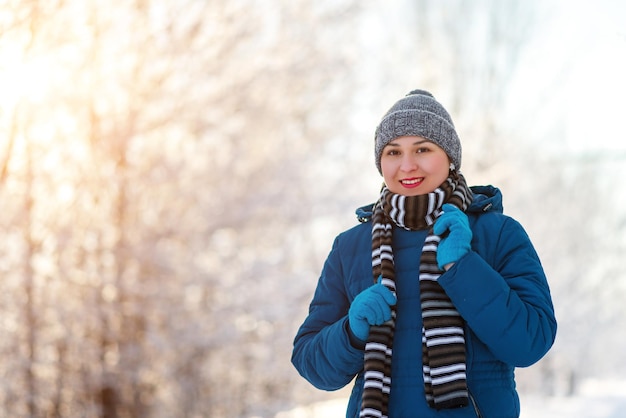 Portrait of a young happy girl woman in winter clothes