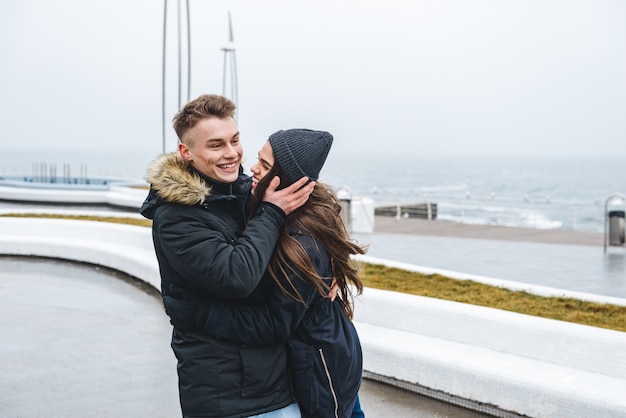 portrait of a young happy loving couple walking at the beach outdoors.