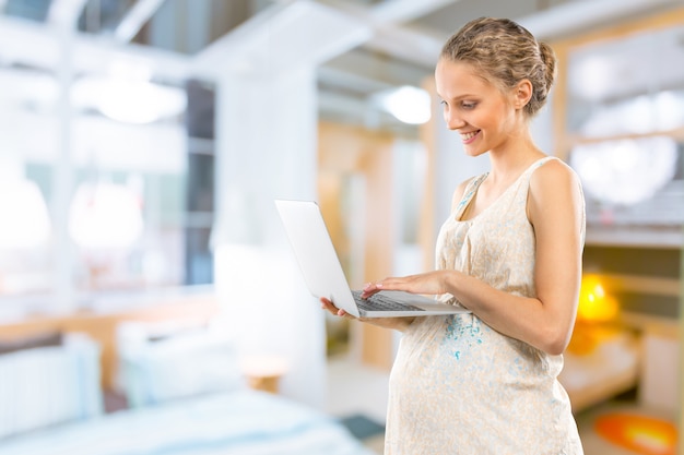 Portrait of the young happy smiling pregnant woman