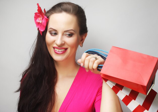 Portrait of young happy smiling woman with shopping bags