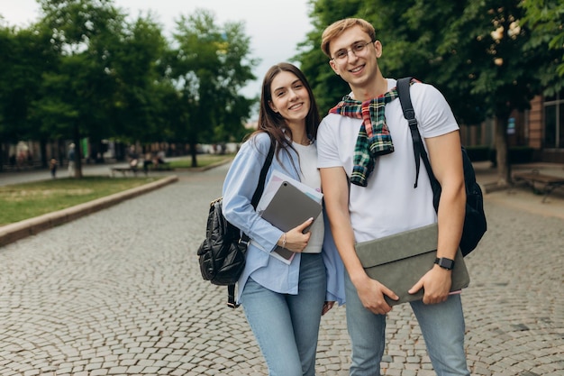 Portrait of young happy students outdoors