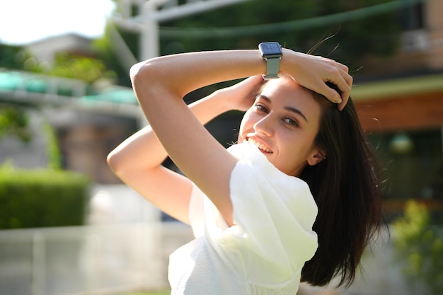 Portrait of young happy woman looks in camera