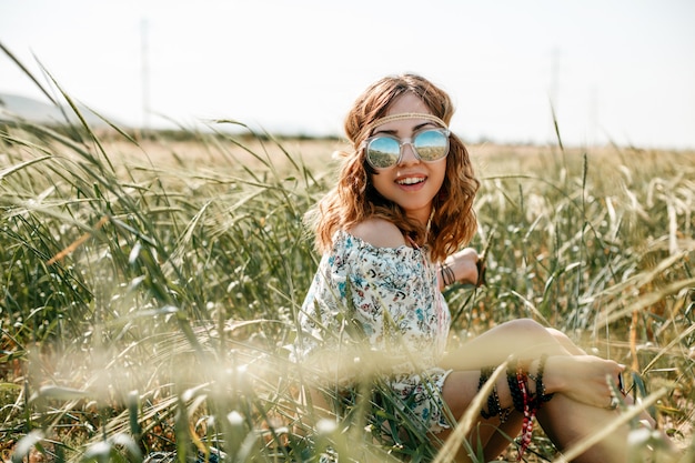 Portrait of a young hippie girl on a wheat field