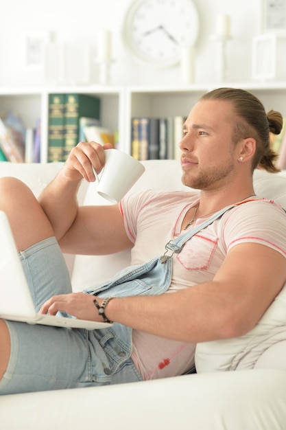 Portrait of a young hipster man at home