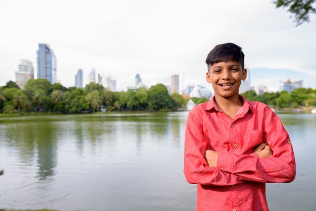 Portrait of young Indian boy relaxing at the park