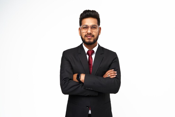 Photo portrait of young indian businessman with crossed arms on white isolated background.
