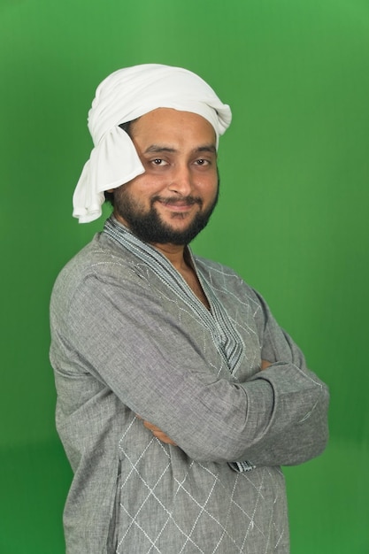 portrait of young indian farmer smiling and looking at camera isolated on background green screen