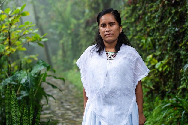 Portrait of a young indigenous woman wearing traditional Mexican costume in the rainforest