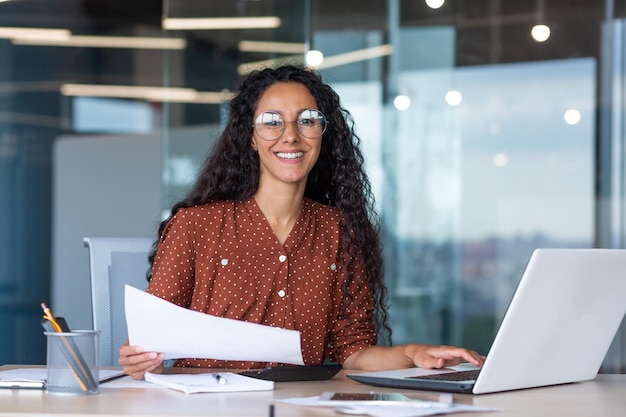 Portrait of a young latin american woman designer architect freelancer he sits in the office at a