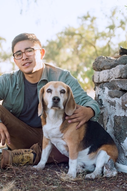 Portrait of a young latin man with his dog