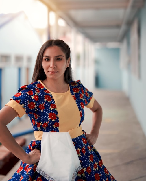 Portrait of young latin woman looking at the camera dressed with chilean national custome x9