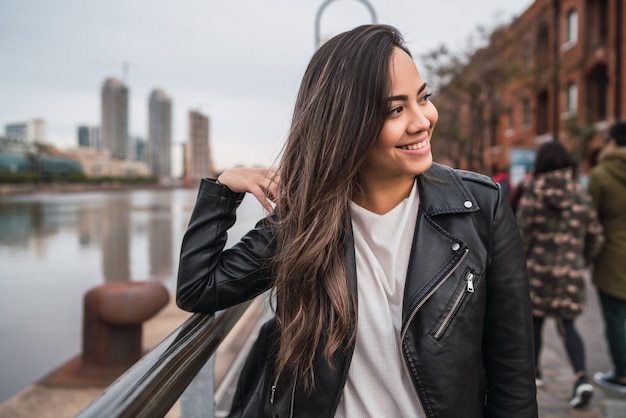 Portrait of young latin woman posing outdoors in the street. Urban concept.