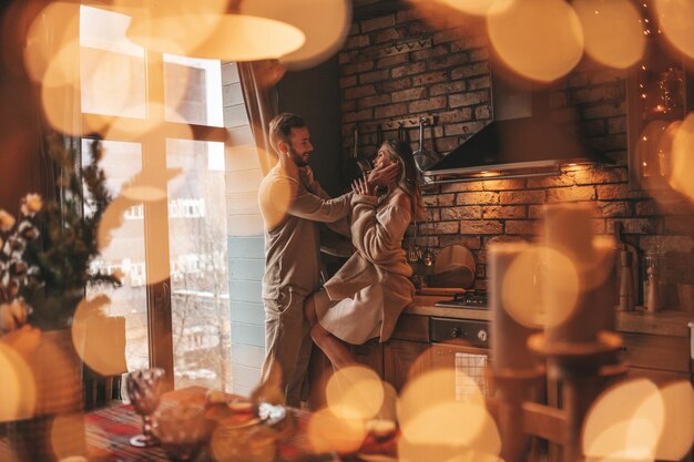 Portrait of young lovely couple hugging indoor eve 25 december