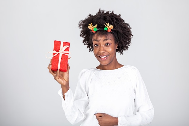 Portrait of young lovely nice sweet glamorous black girl lady, carrying gift box, wondering about surprise. 