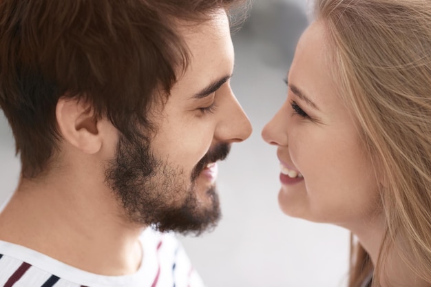 Portrait of young loving couple on blurred background closeup