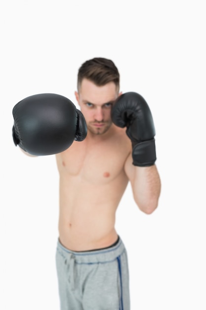 Portrait of young male boxer punching