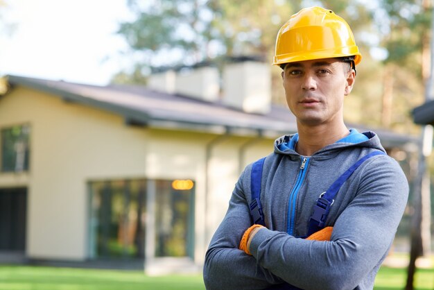 Portrait of young male engineer in hard hat looking at camera