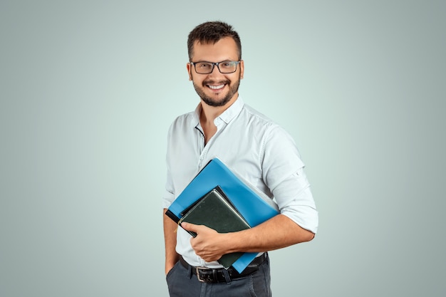 Photo portrait of a young male teacher on a light background