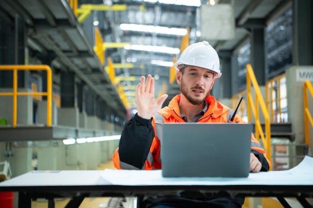 Portrait of Young male technician sitting on the table in skytrain repair station Check the details