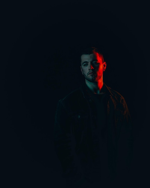 Photo portrait of young man against black background