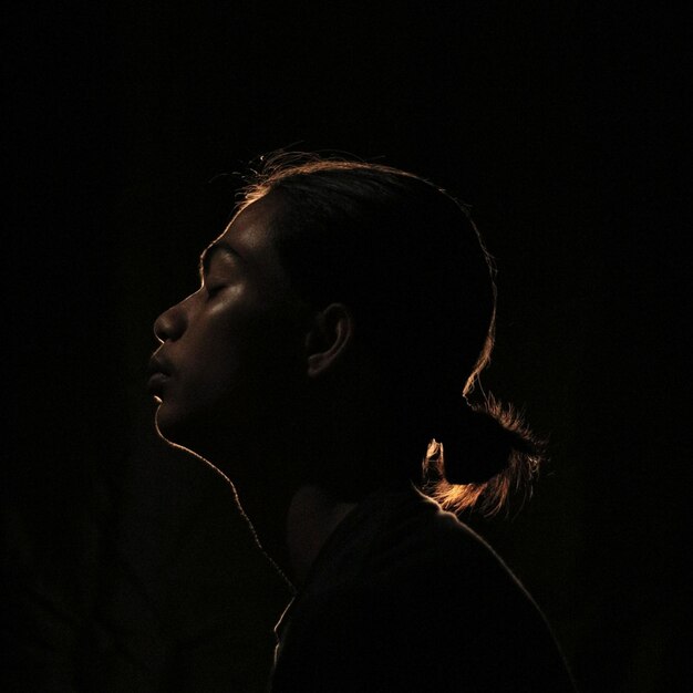 Photo portrait of young man against black background