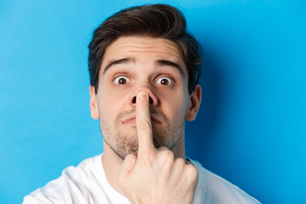 Portrait of young man against blue background