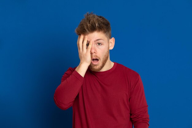 Portrait of young man against blue background