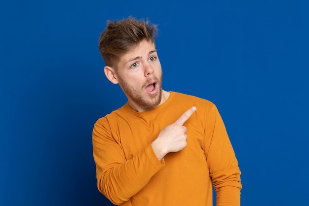 Portrait of young man against blue background