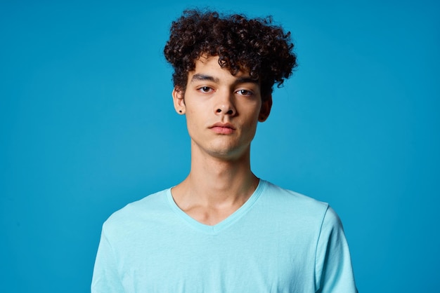 Portrait of young man against blue background