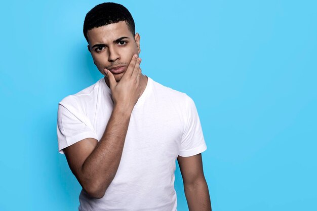 Portrait of young man against blue background