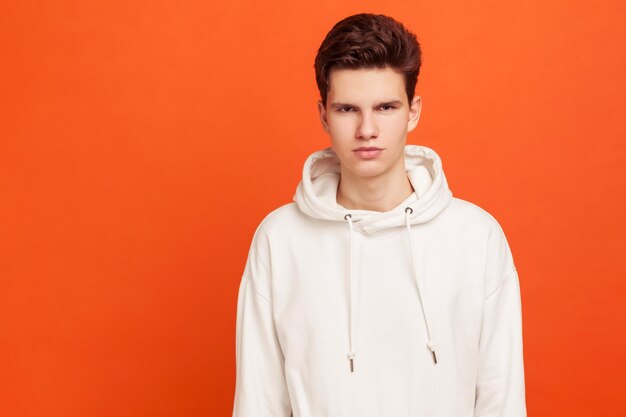 Portrait of young man against orange background