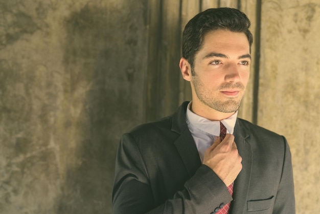 Portrait of young man against wall