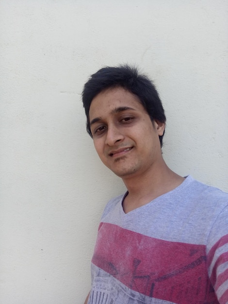 Portrait of young man against wall