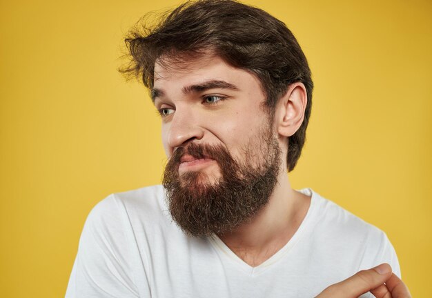 Portrait of young man against yellow background