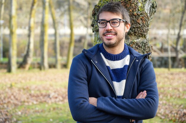 Portrait Of Young Man In Autumn Park.