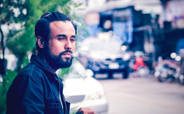 Portrait of young man in city street