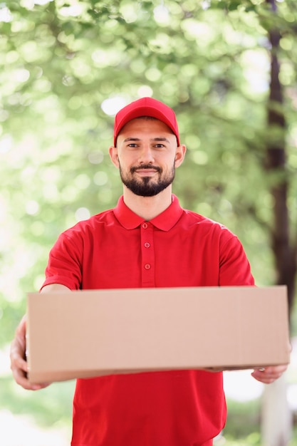 Portrait of young man delivering parcel