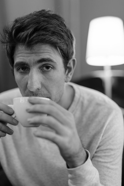 Portrait of young man drinking coffee