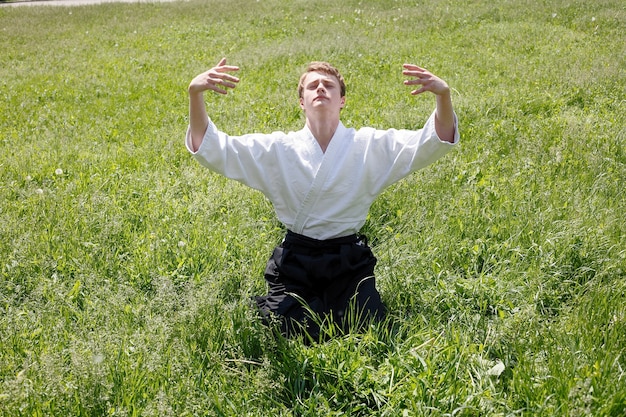 Portrait of young man exercises at the nature park