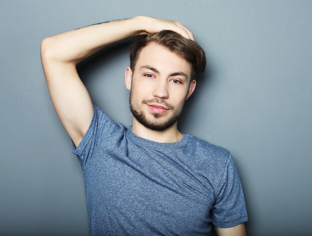 Portrait of a young man on a gray background