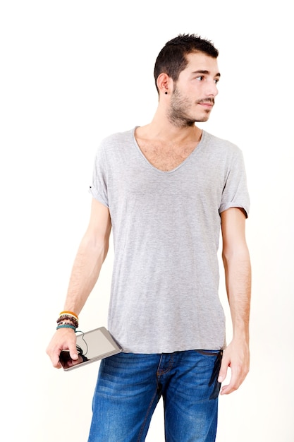 Portrait of a young man in grey shirt using tablet.