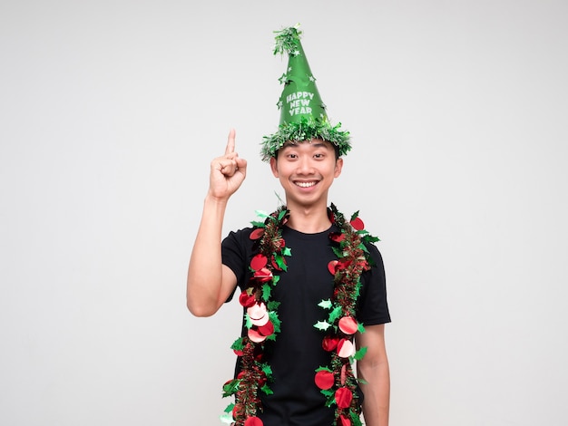 Portrait young man happy face with green hat and tassel colorful point finger above