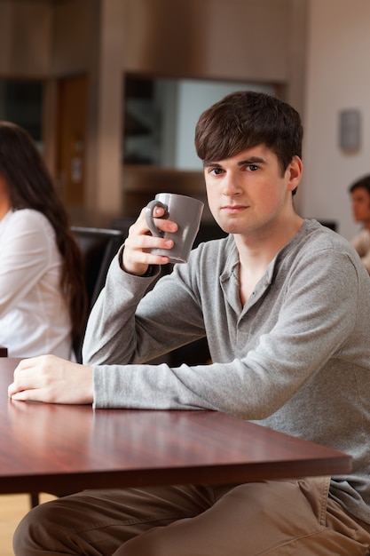 Portrait of a young man having a coffee