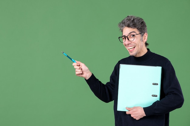 portrait of young man holding documents studio shot on green background business teacher job