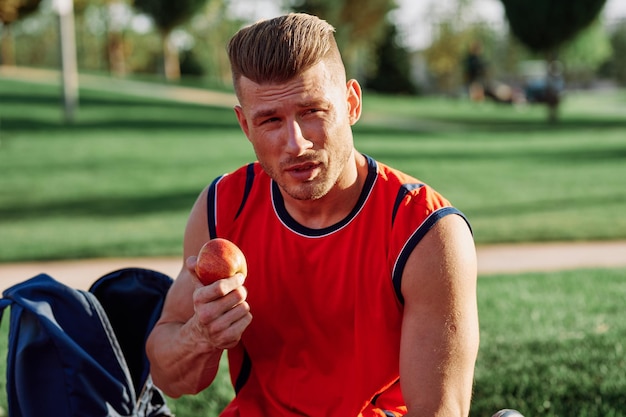 Portrait of young man holding food at park