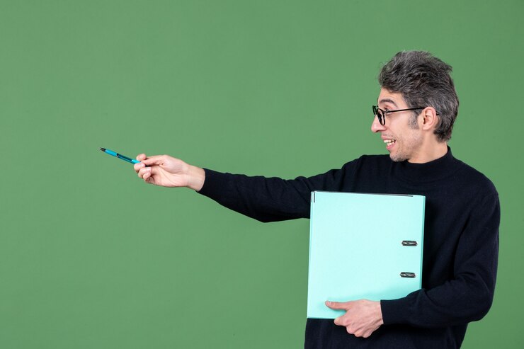 portrait of young man holding green document on green background business lesson teacher