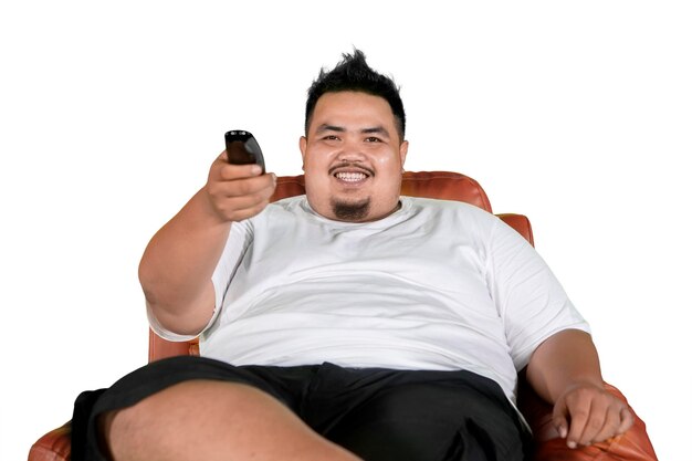 Photo portrait of young man holding remote control on white background