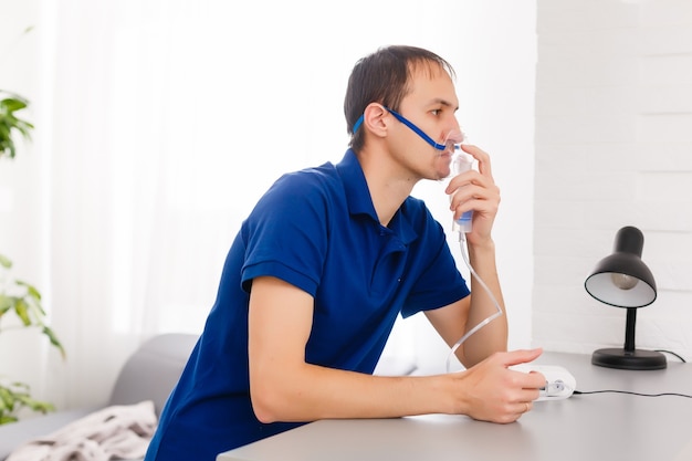 Portrait Of Young Man Inhaling Through Inhaler Mask