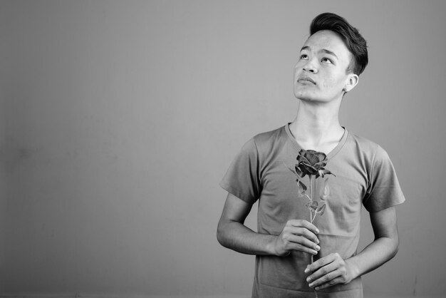 Portrait of young man looking away against white background