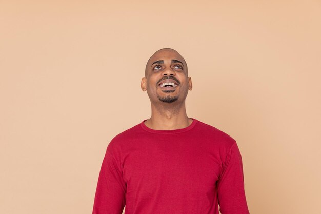 Portrait of young man looking away against white background